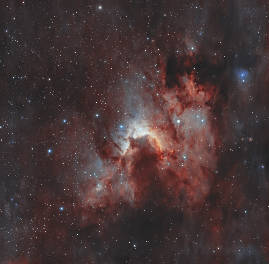 Astrophotography shot of the Cave Nebula, highlighting its intricate dust clouds and star-forming regions.